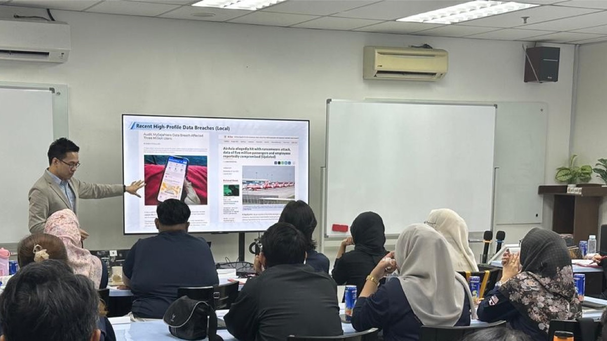 Edwin Lee leading a PDPA training session, presenting recent Malaysian data breach cases reported in the press