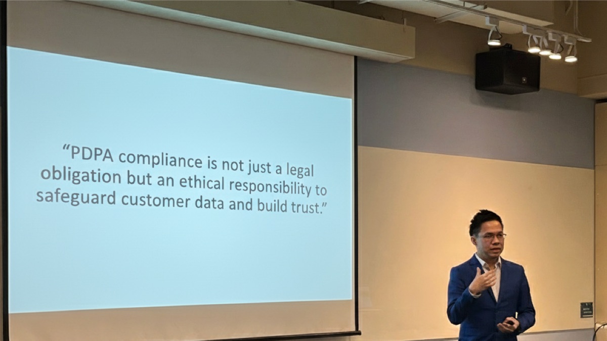 Edwin Lee speaking on PDPA compliance, beside a slide reading “PDPA compliance is not just a legal obligation but an ethical responsibility to safeguard customer data and build trust.”